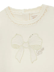Closer look at the Guess dress showing detail of the sequin bow design on the chest.