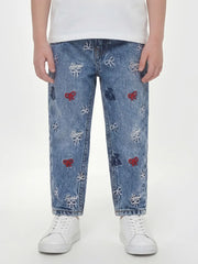 Closer look at the Guess embroidered jeans showing detail of the embroidered bow pattern.