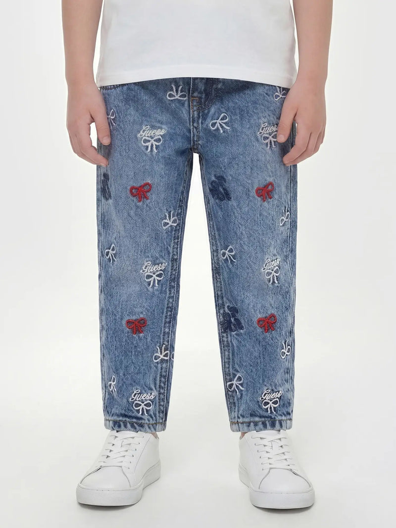 Closer look at the Guess embroidered jeans showing detail of the embroidered bow pattern.