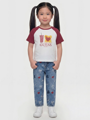 Girl modelling the Guess embroidered jeans.