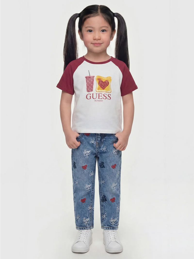 Girl modelling the Guess embroidered jeans.