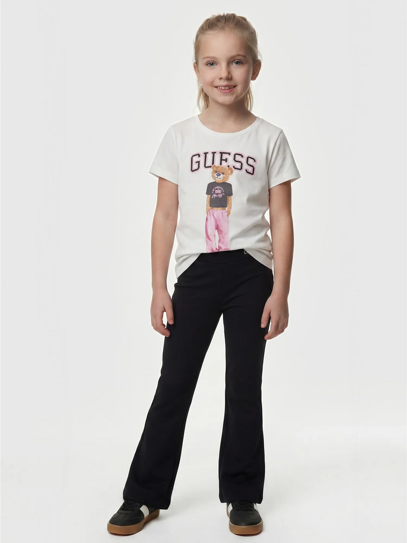 Smiling Girl modelling the Guess flared leggings.