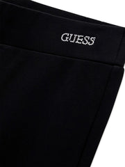 Closer look at the Guess flared leggings showing detail of the rhinestone logo at the hip.