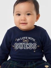 Baby girl wearing the Guess plaid skirt set.