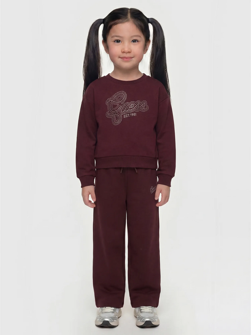 Girl wearing the Guess rhinestone logo tracksuit.
