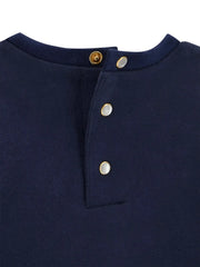 Closer look at the Guess navy top showing detail of the pearlescent button fasteners.