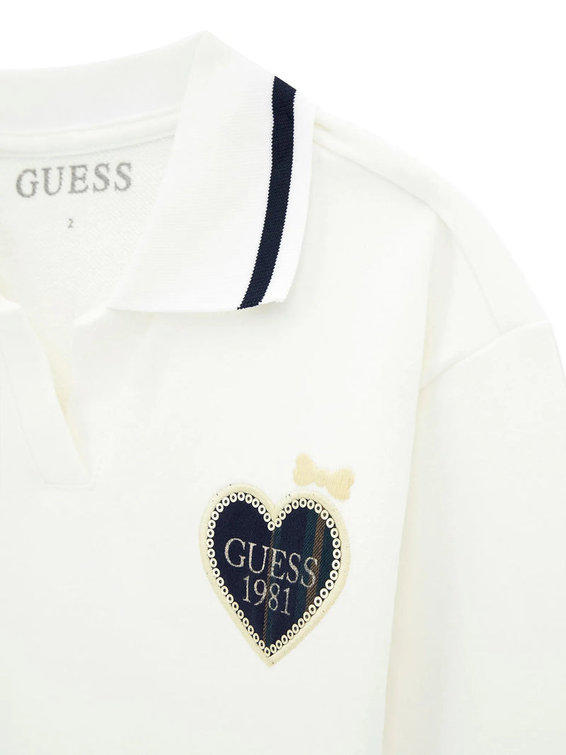 Closer look at the white top showing detail of the plaid heart logo.