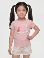 Girl wearing the Guess strawberry logo t-shirt.