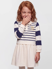 Smiling Girl modelling the Guess striped polo dress.