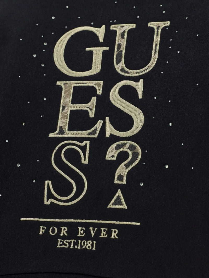 Closer look at the Guess black sweatshirt showing detail of the gold embroidered logo.