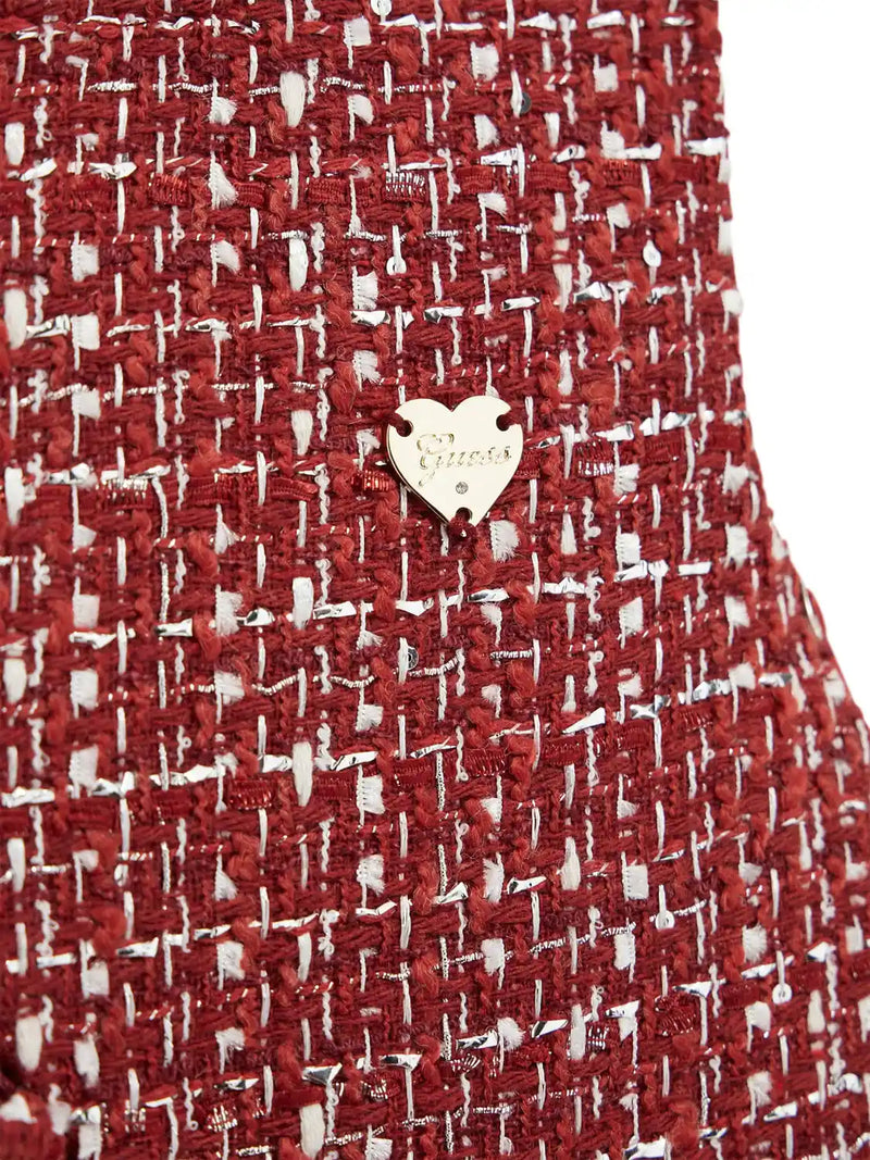 Closer look at the Guess tweed dress showing detail of the gold logo badge.