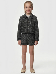 Smiling Girl modelling the Guess tweed shorts.
