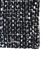 Girl's black tweed shorts with Guess logo badge at the hem.