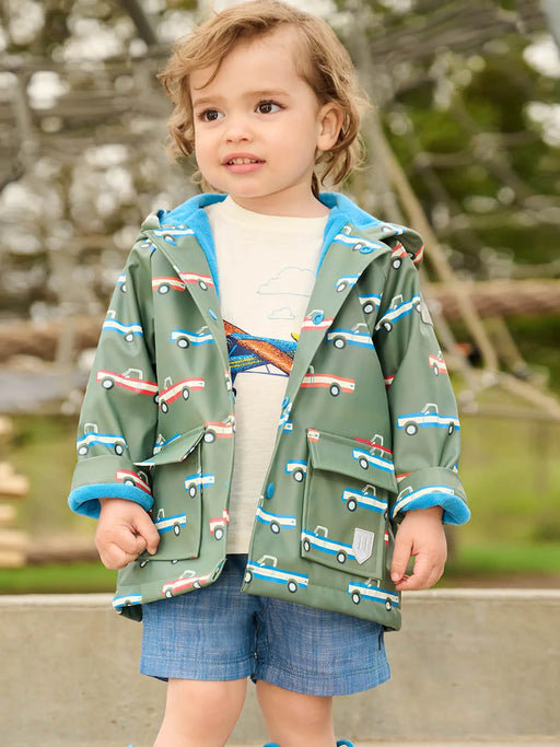 Boy modelling the Hatley big trucks raincoat.