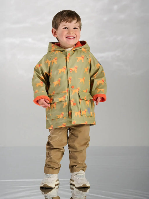Smiling boy modelling the Hatley camping puppy raincoat.