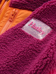 Closer look at the Hatley colourblock sherpa jacket showing detail of the gel logo patch.