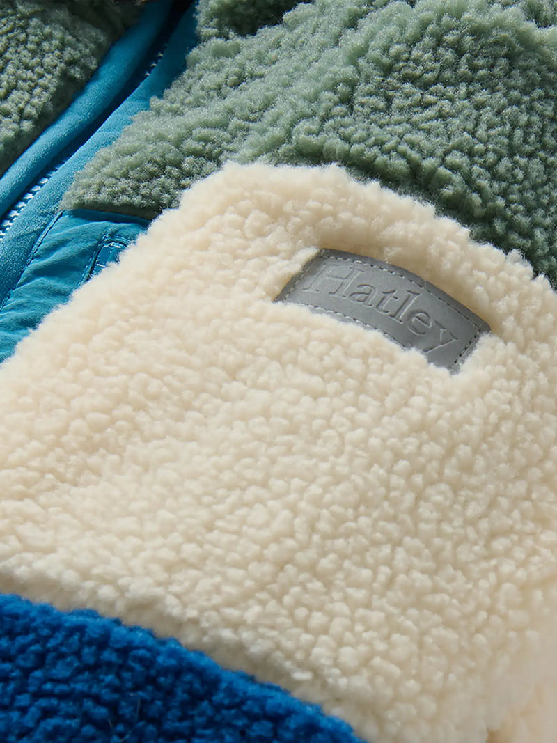 Closer look at the Hatley colourblock sherpa jacket showing detail of the grey logo patch.