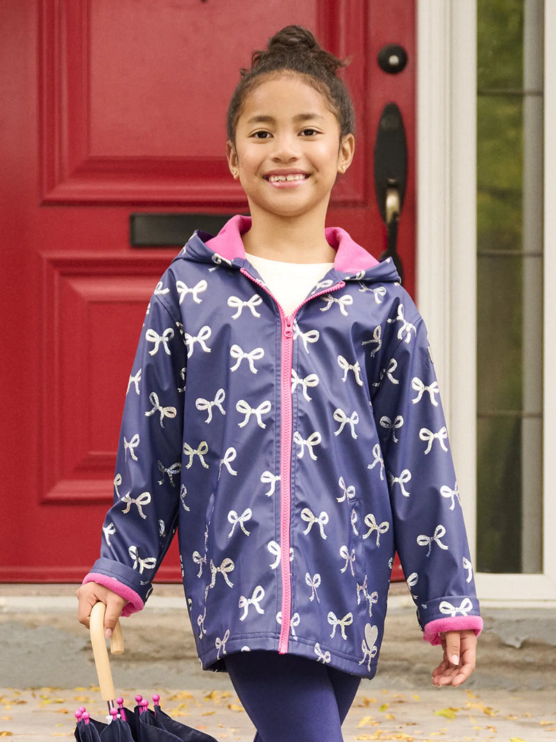 Girl modelling the Hatley foil bows raincoat.