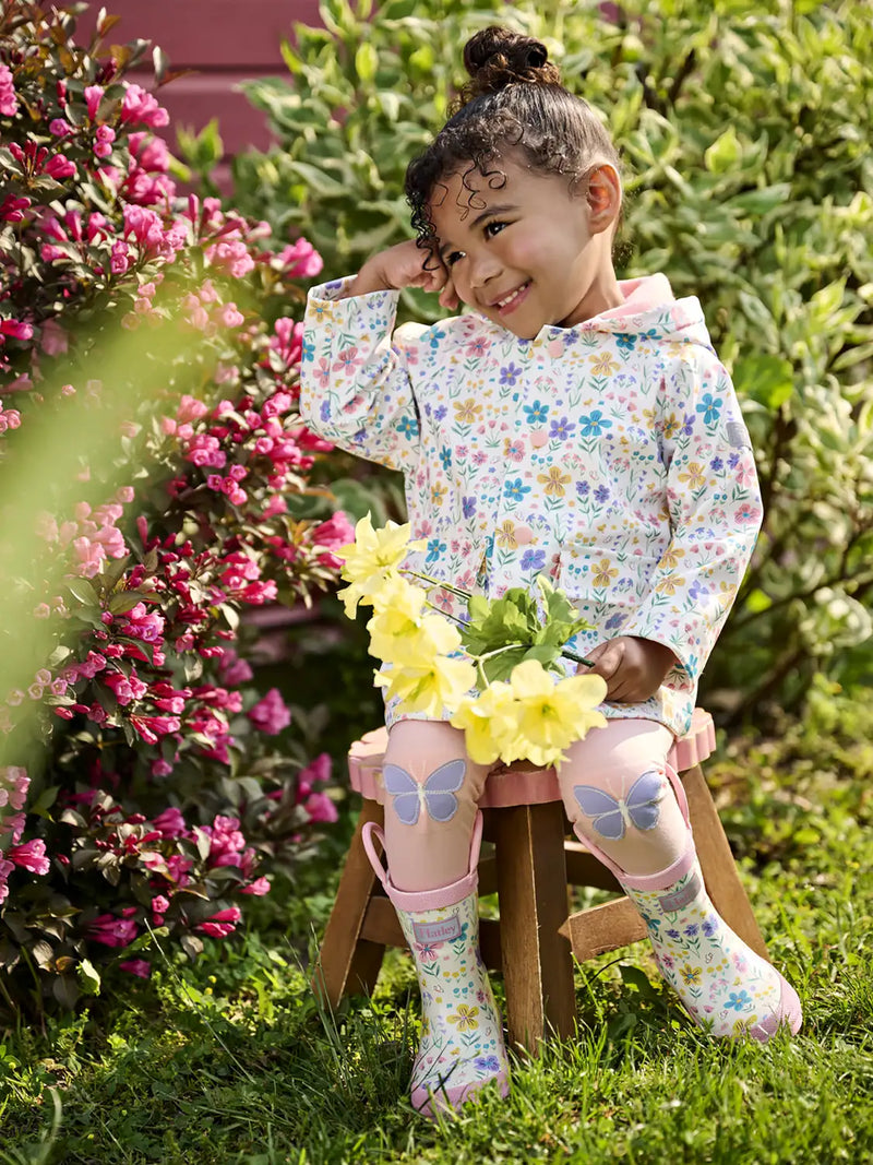Girl wearing the Hatley little garden chicks raincoat.
