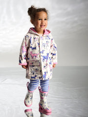 Girl wearing the Hatley little pups raincoat.