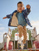 Boy wearing the Hatley t-rex attack raincoat.