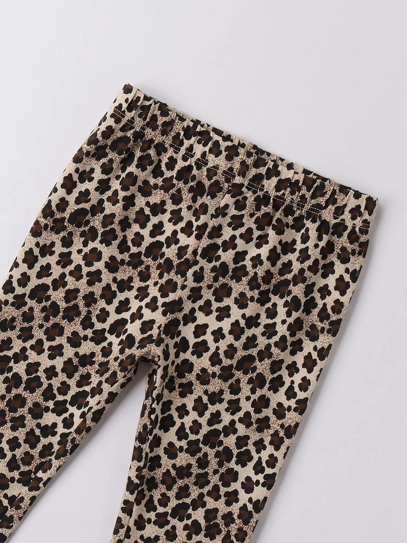 Closer look at the iDo girl's leggings showing detail of the leopard print pattern.