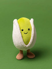 Jellycat amuseables horatio pistachio, modelled against a bright green background.