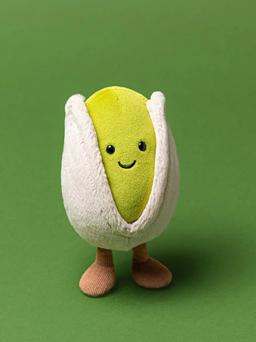 Jellycat amuseables horatio pistachio, modelled against a bright green background.