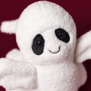 Jellycat ghost bob, modelled against a dark purple background.