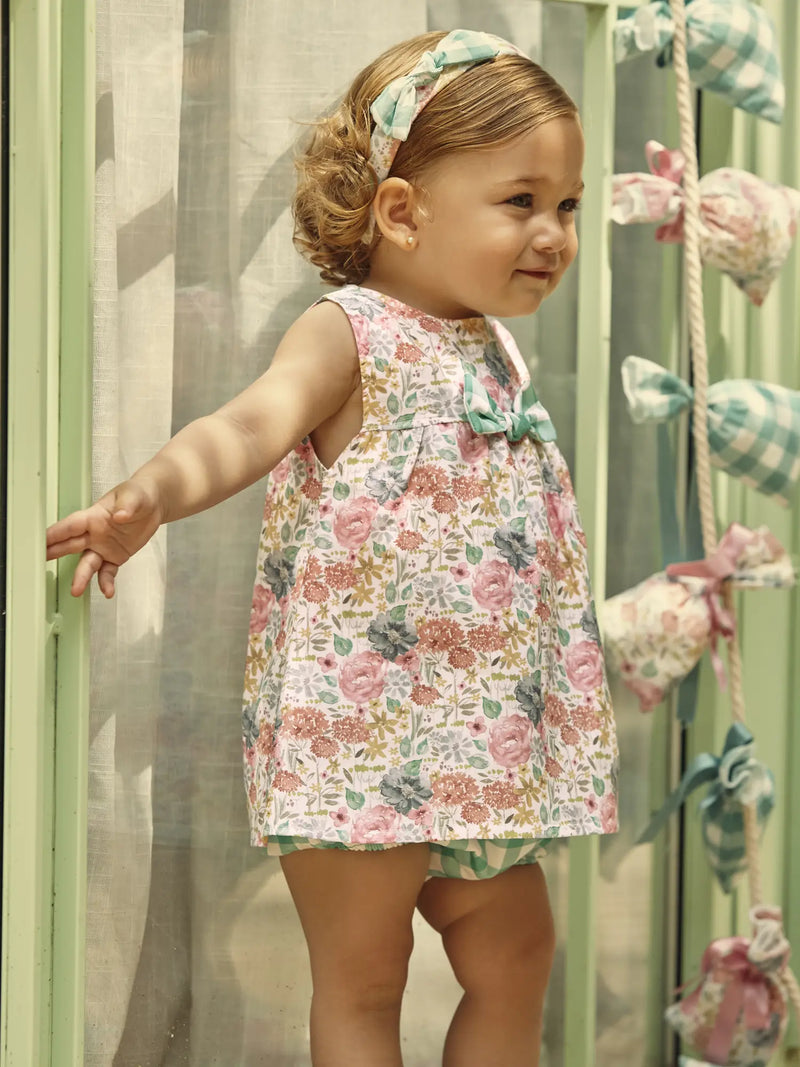 Baby girl wearing the Juliana floral print sleeveless dress.