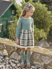 Girl in green knitted dress by Juliana.