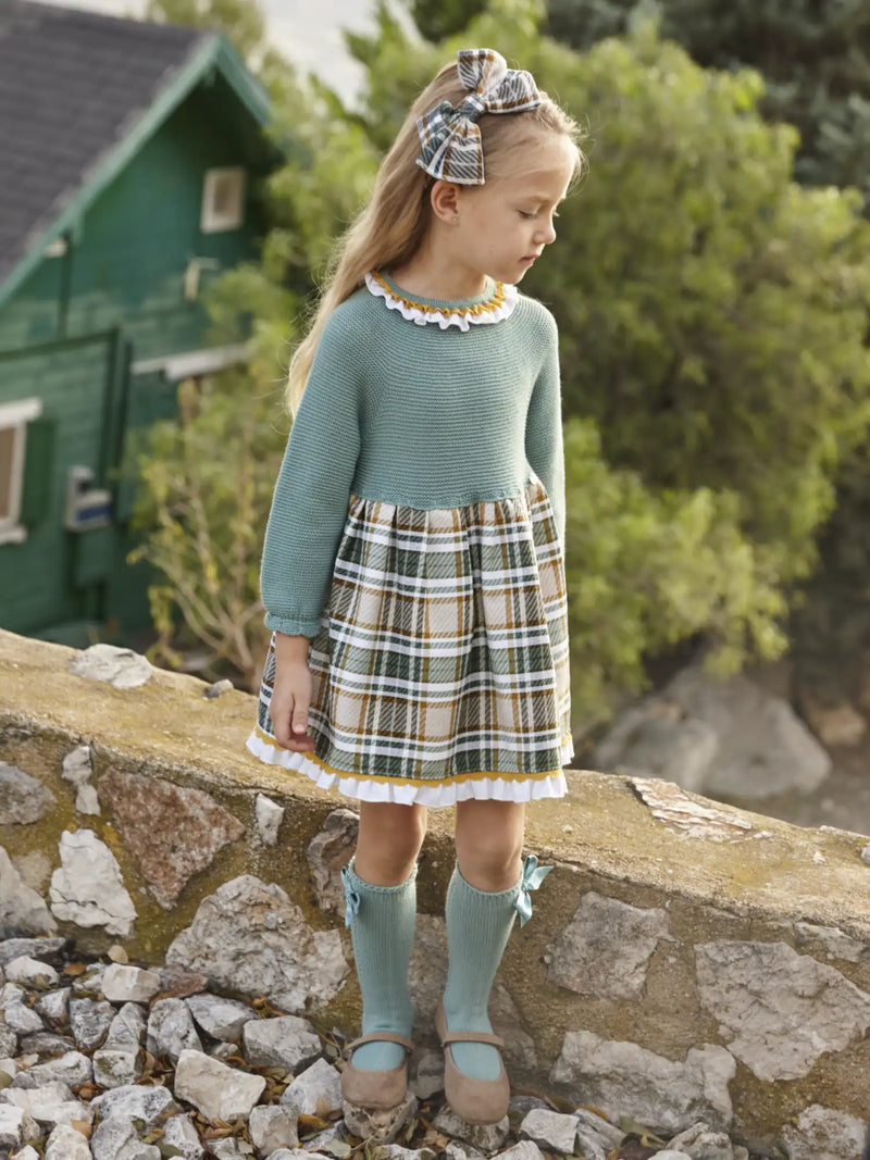 Girl in green knitted dress by Juliana.