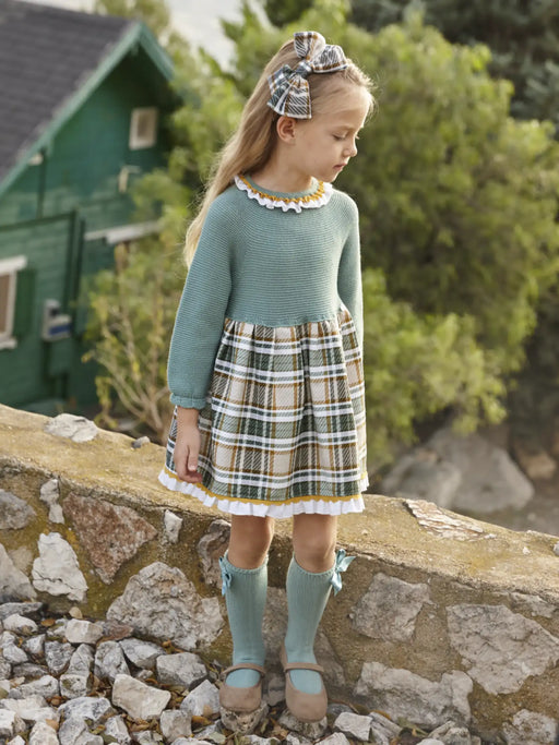Girl in green knitted dress by Juliana.