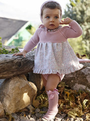 Baby girl modelling the Juliana knitted dress.