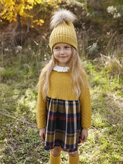 Girl wearing the Juliana knitted dress.