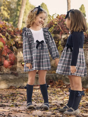 Girl in navy plaid dress by Juliana.