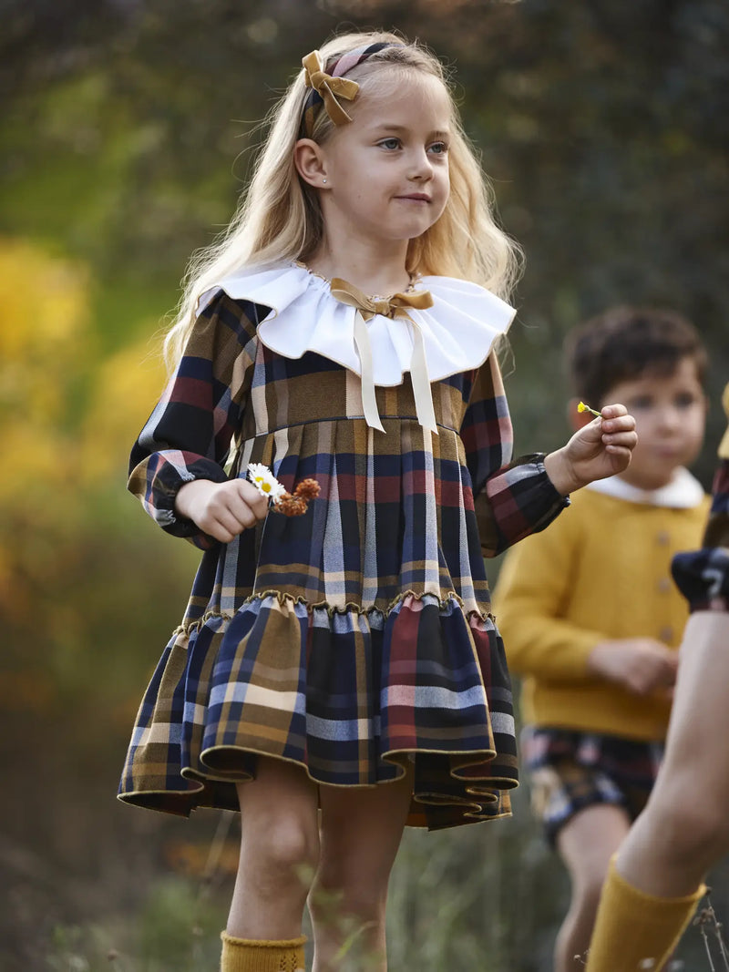 Smiling girl modelling the Juliana plaid dress.