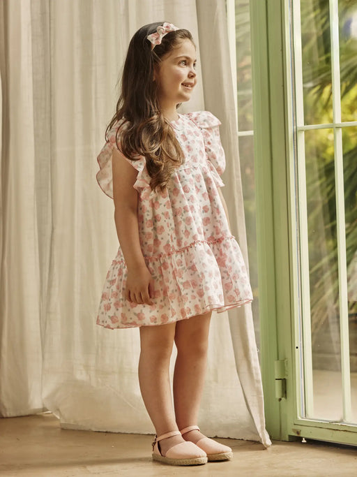 Baby girl wearing the Juliana rose print dress.