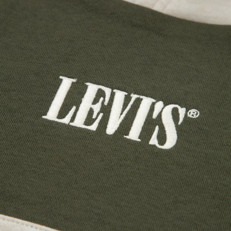 Closer look at the Levi's colourblock tracksuit showing detail of the embroidered logo on the chest.