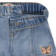 Closer look at the Levi's denim shorts showing detail of the embroidered butterfly.