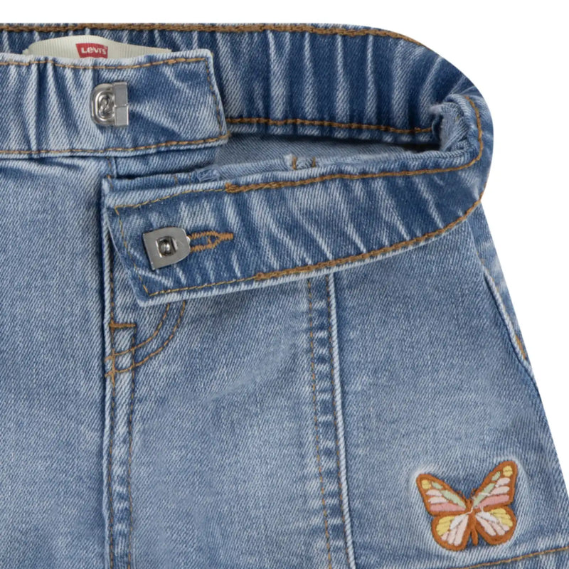 Closer look at the Levi's denim shorts showing detail of the embroidered butterfly.