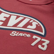 Closer look at the bright red bodysuit showing detail of the racing logo.