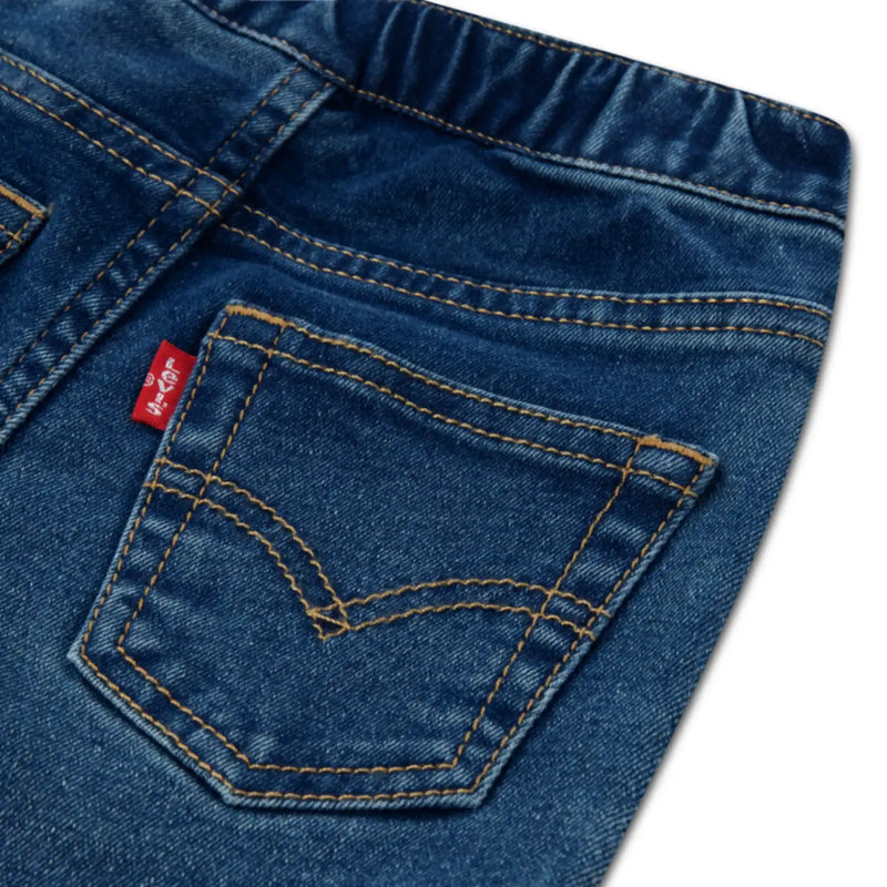 Closer look at the Levi's jeans showing detail of the red logo tag on the back pocket.