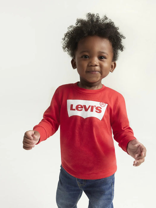 Smiling boy modelling the Levi's long sleeve batwing t-shirt.