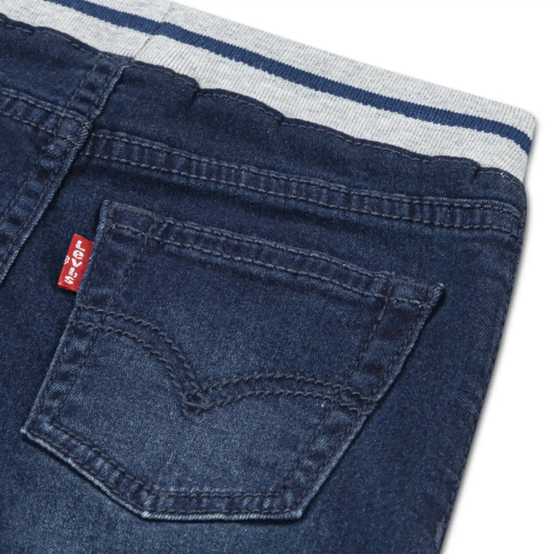 Closer look at the Levi's pull on jeans showing detail of the red logo tag on the back pocket.