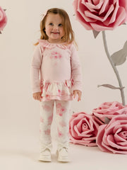 Baby girl modelling the Little A daisy leggings set.