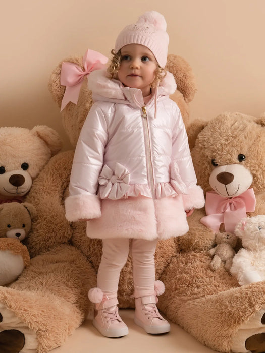 Baby girl wearing the Little A honey padded jacket.