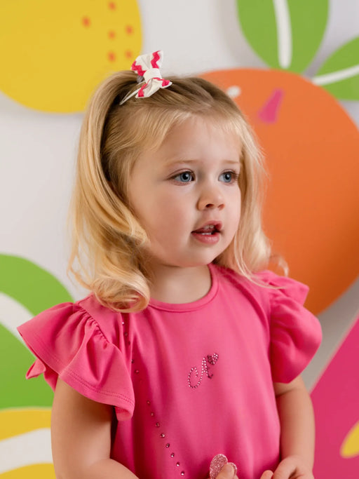 Baby girl modelling the Little A priscilla bow clips.