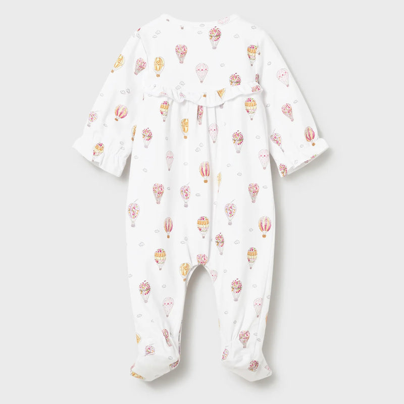 Baby girl's white babygrow with balloon pattern.