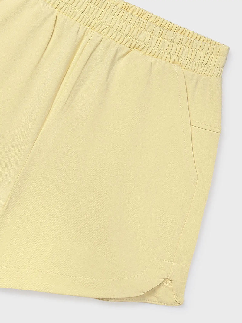 Closer view of the girls yellow track shorts.